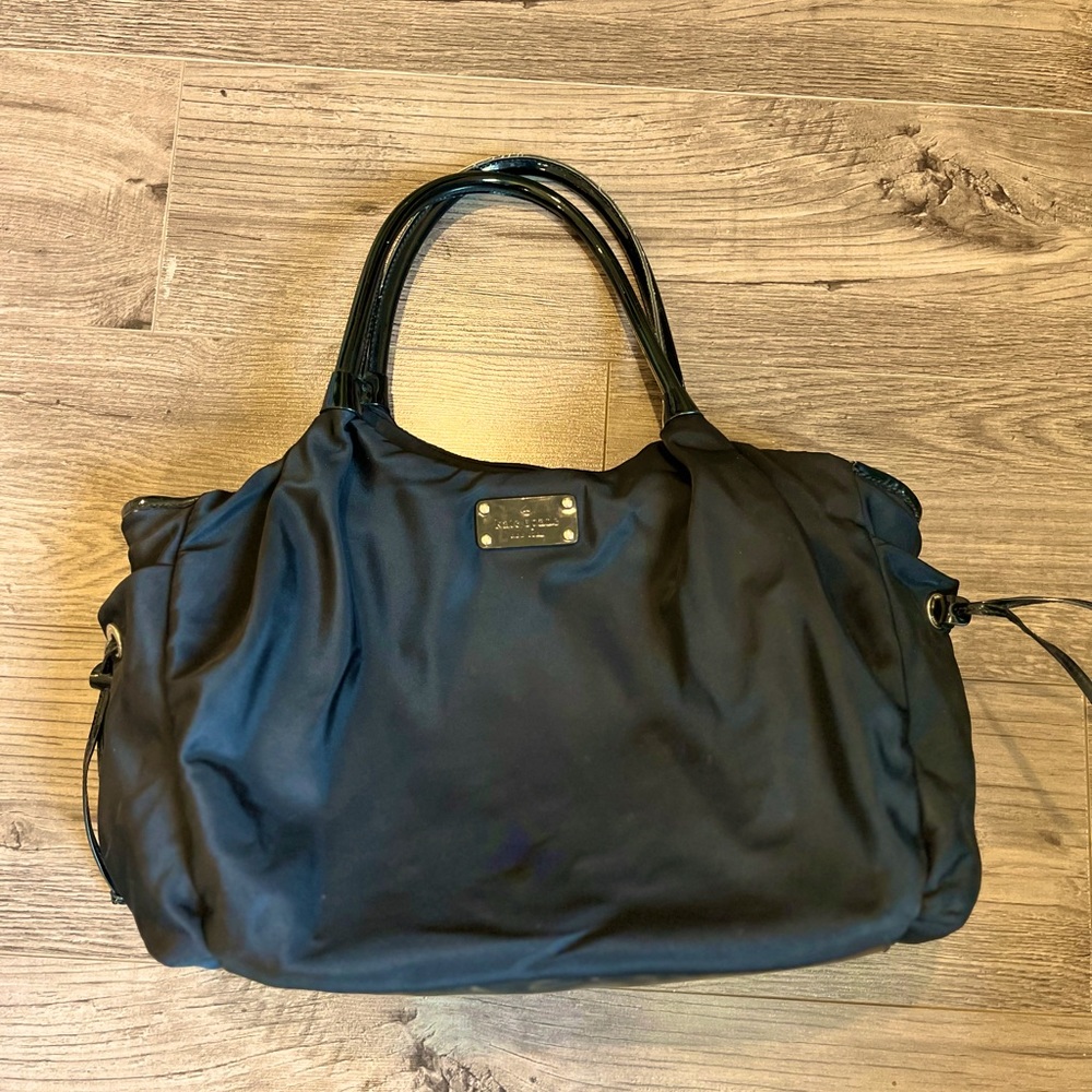 Exterior has two side pockets with draw string (great for bottles) and top zip.